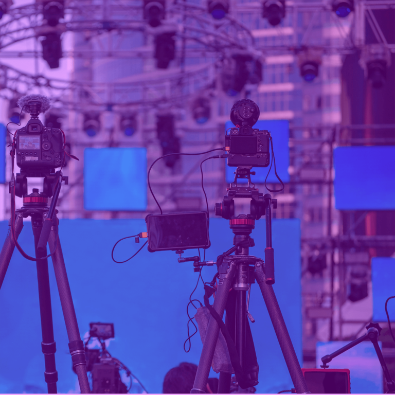 behind the scene with camera pointing on the stage with the stage lights