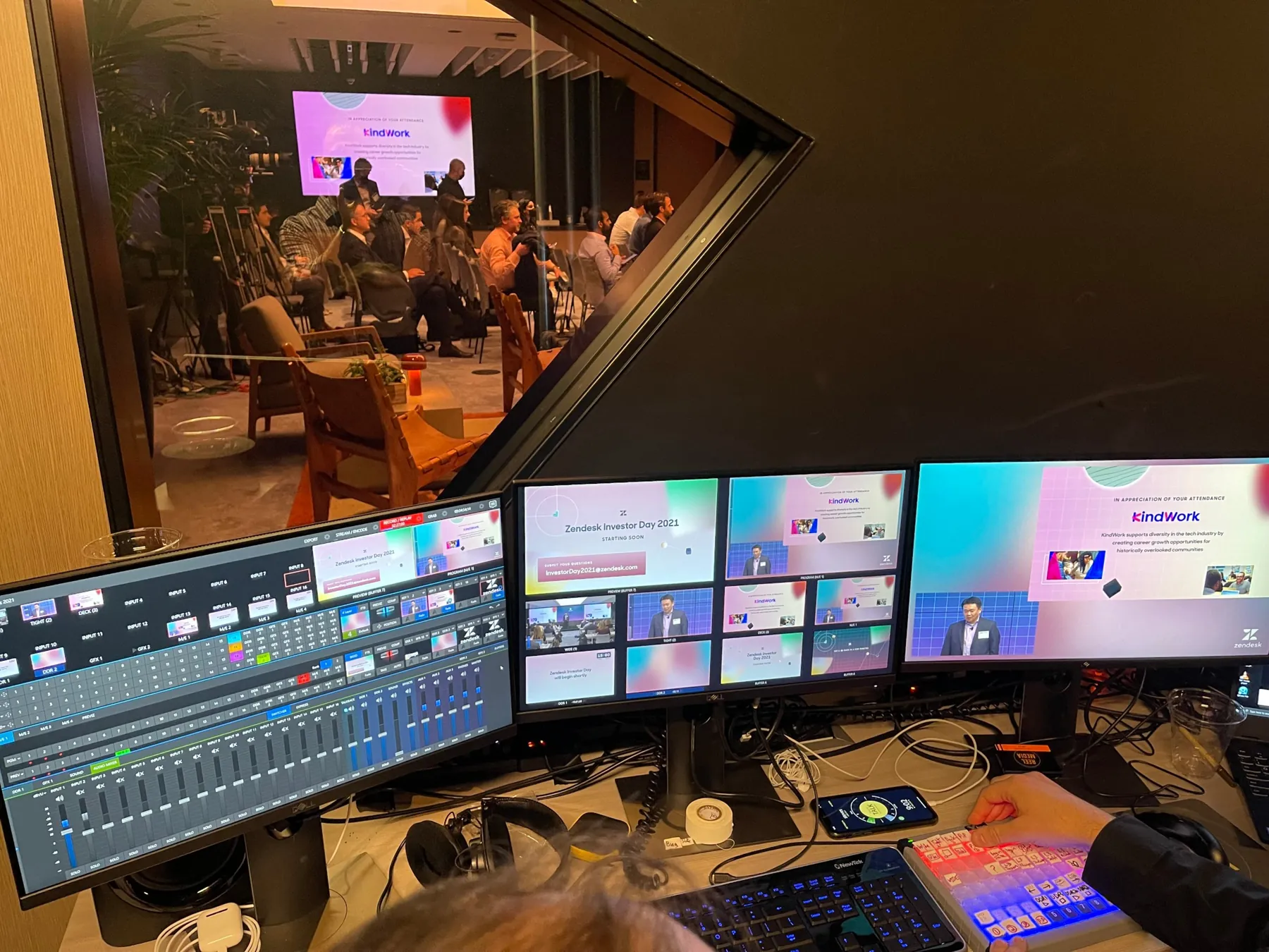 The control room at Zendesk Investor Day 2021: a switcher and multiview monitors showing the live program, with the audience visible through the window.