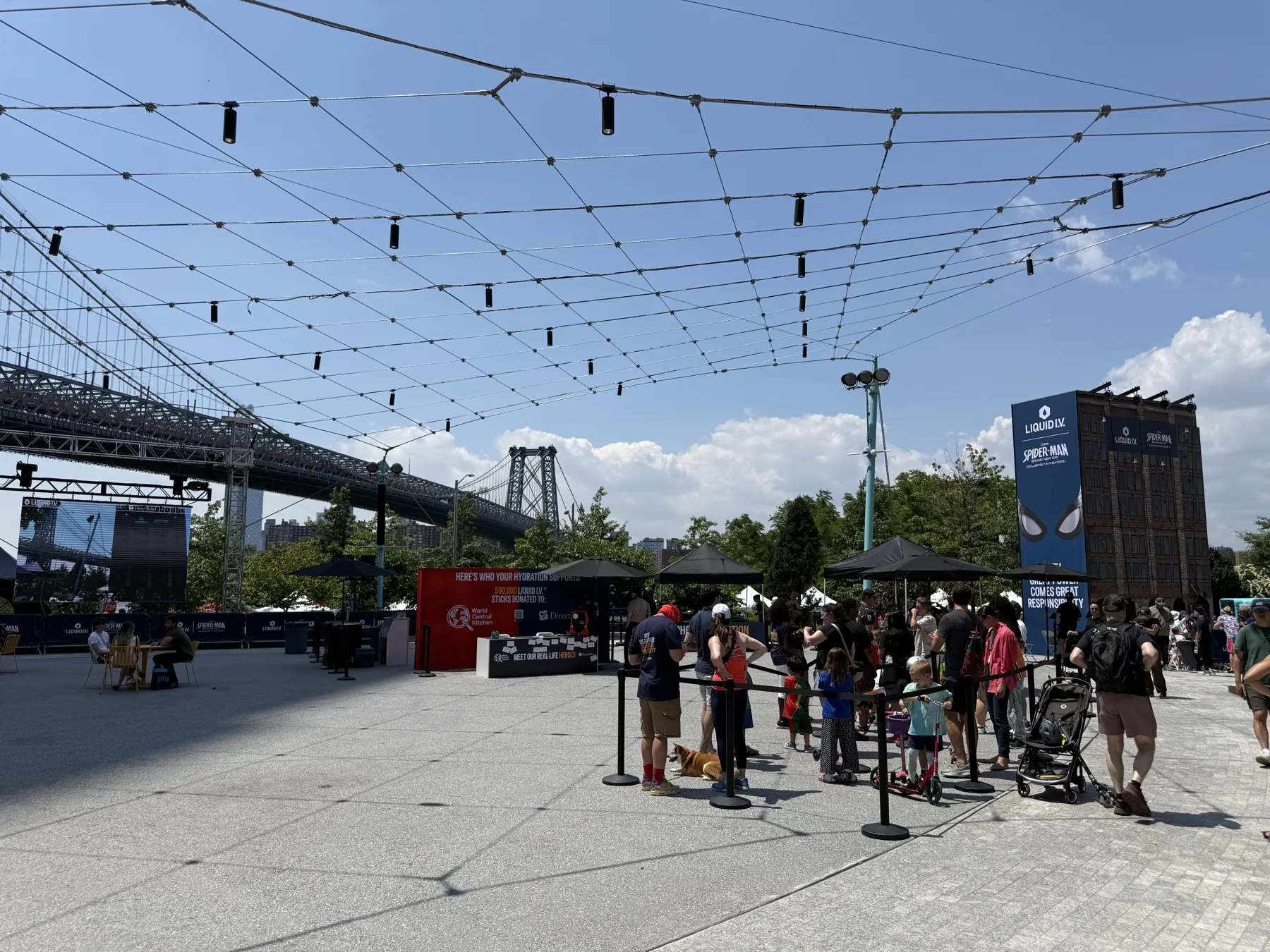 Guests line up at an outdoor brand activation beside the Williamsburg Bridge.