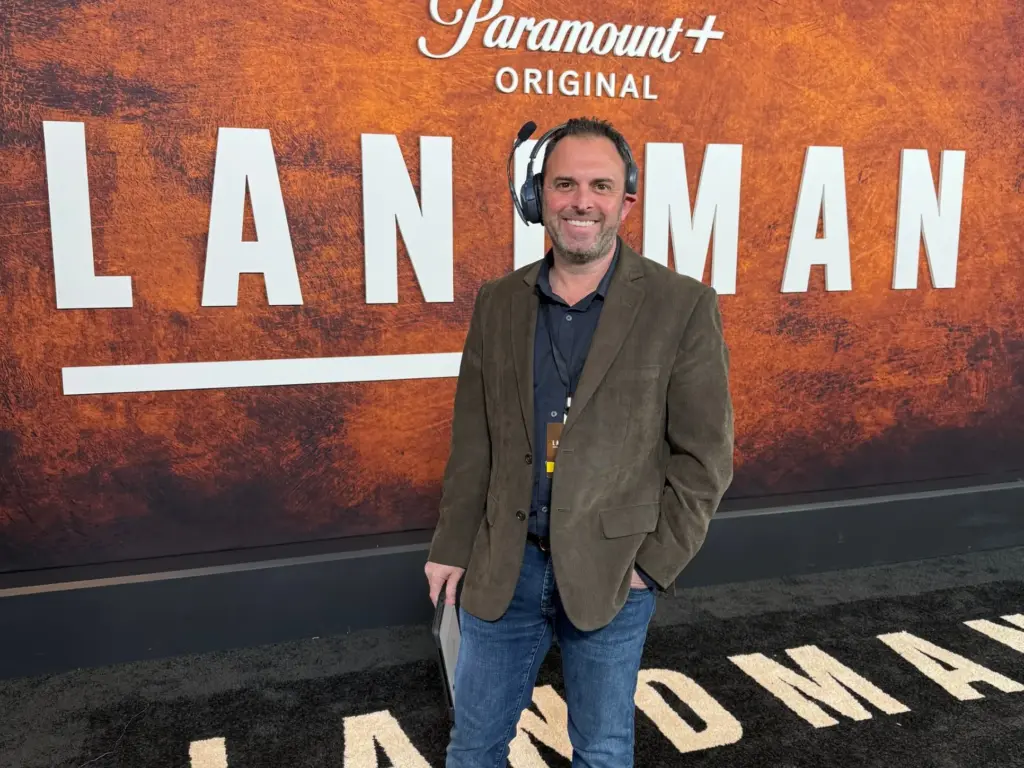 Jason Cohen, founder and executive producer of Production Solved, on headset at a series premiere red carpet.