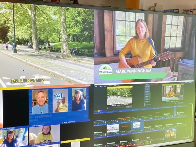 A production monitor wall during the YAI Central Park Challenge virtual broadcast: program and preview feeds above a grid of remote guests and playback controls.